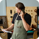 Contractor takes a call inside his workshop